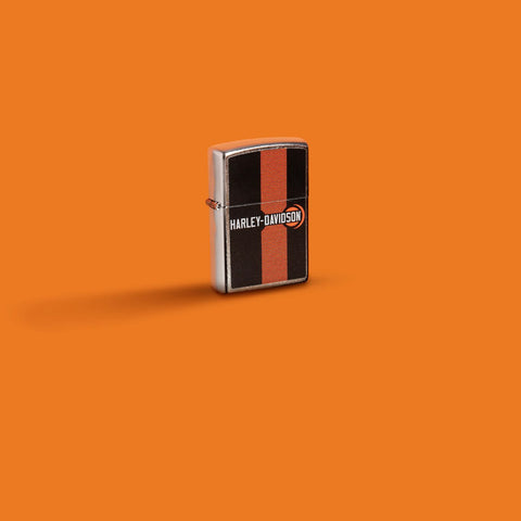 Glamour shot of Zippo Harley-Davidson Logo Design Street Chrome Windproof Lighter standing in an orange scene.